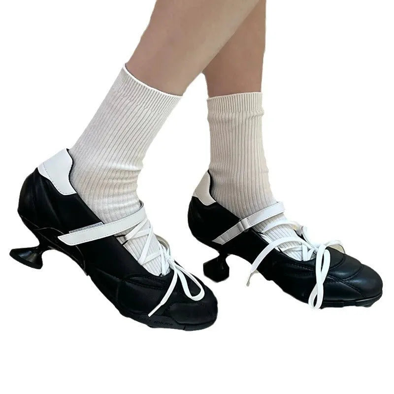 Women's silver lace-up sports shoes with a bow on the front, round toe, and leather stitching details on the microfiber upper.