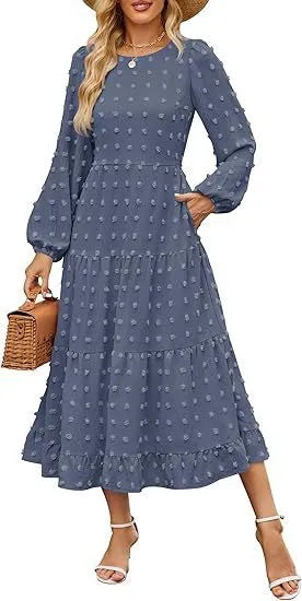 A woman wearing a beige high waist long sleeve dress with ruffle details on a autumn day.