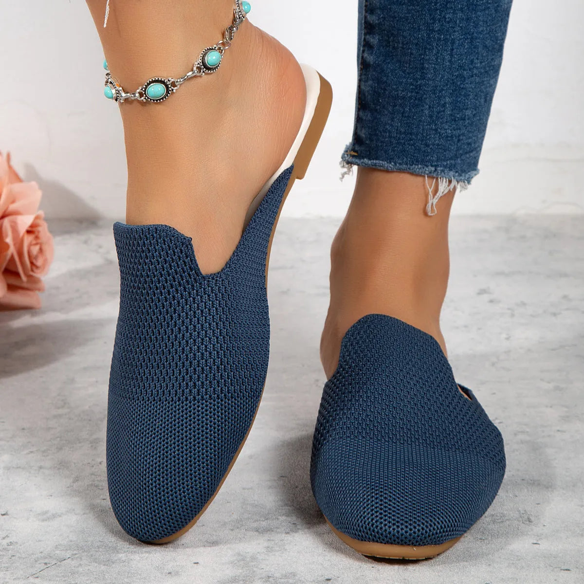 A pair of apricot-coloured mesh slip-on sandals with a round toe and flat rubber sole on a plain background.