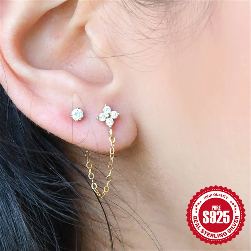 Golden tone sterling silver ear clip studs with a geometric flower, tassel, and chain design.