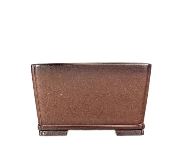 Brown handmade purple clay square flower pot with classical design on a wooden surface.