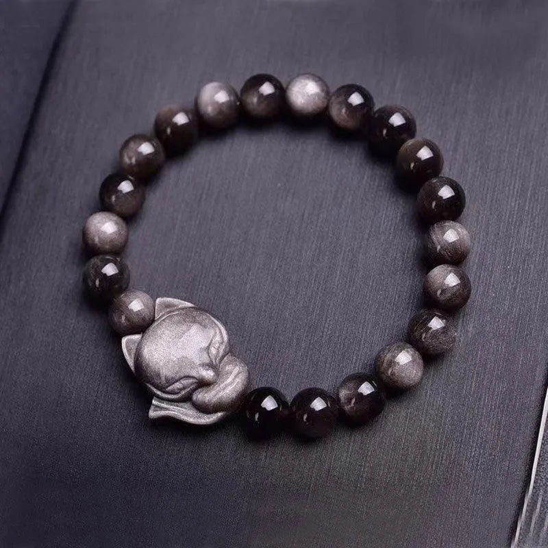 Obsidian bracelet with fox ring charm on 8mm polished black stone beads showing adjustable sliding knot closure