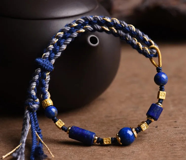 Hand-woven lapis lazuli flexible wire bracelet with simple ethnic design on white background