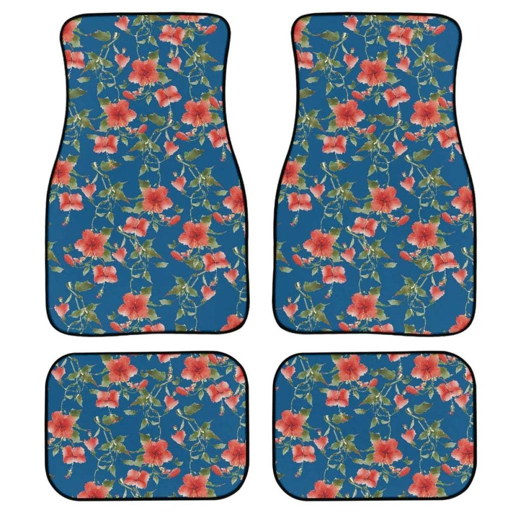 Black four-piece rubber car floor mat set with textured surface, shown fitted in a vehicle footwell.