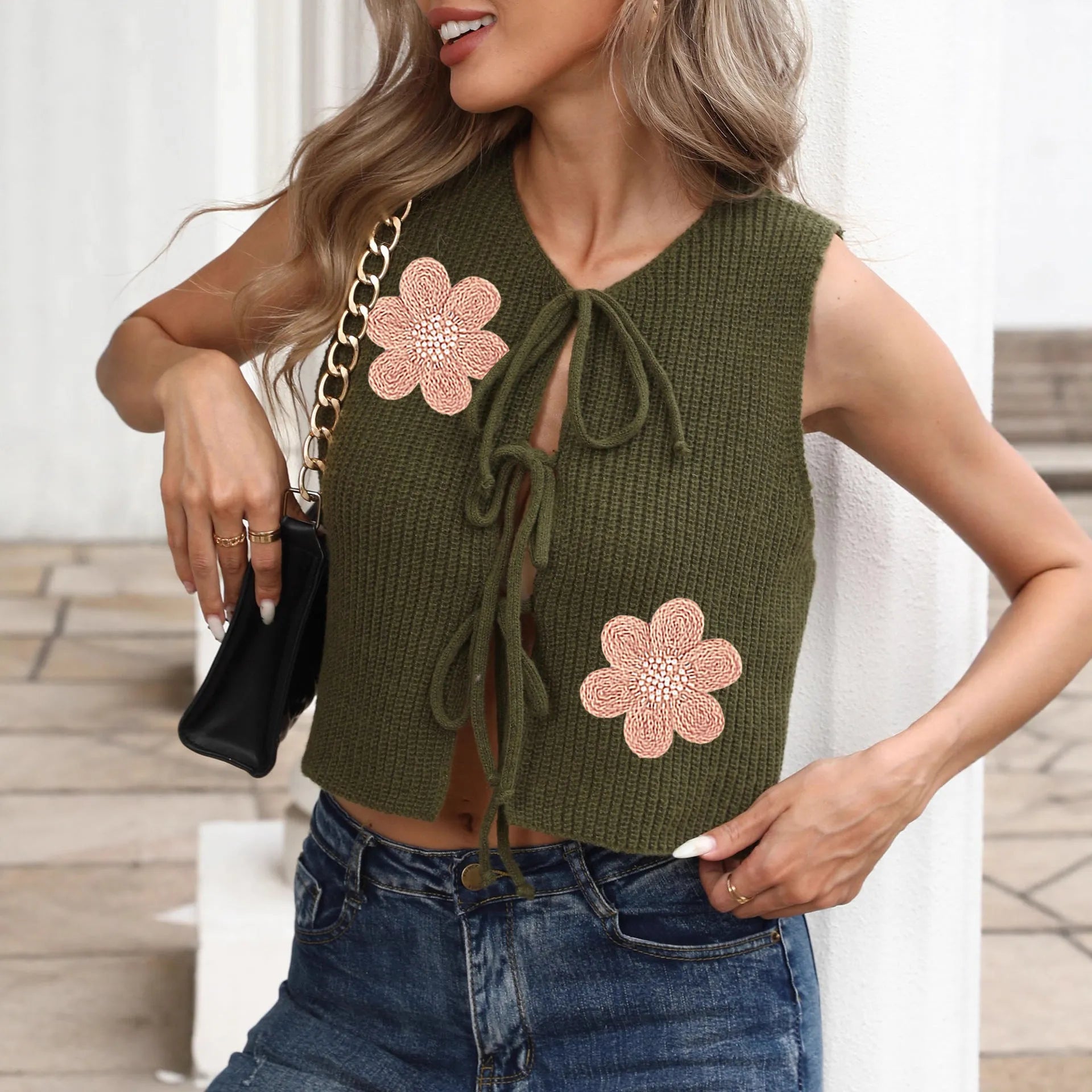 White ladies' sleeveless vest cardigan with lace-up bow front and apricot flower accents.