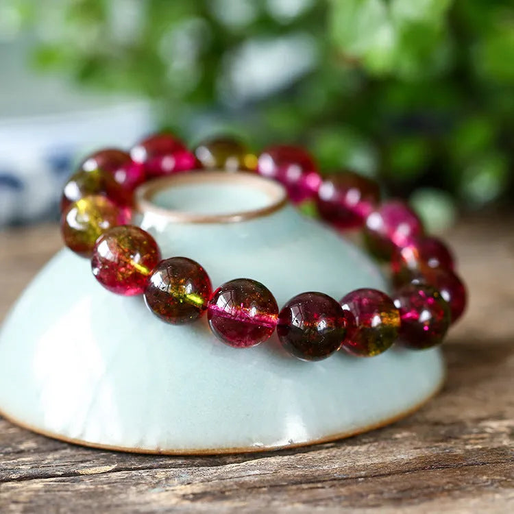 Handmade watermelon crystal bracelet for women showing pastoral design on a wrist.