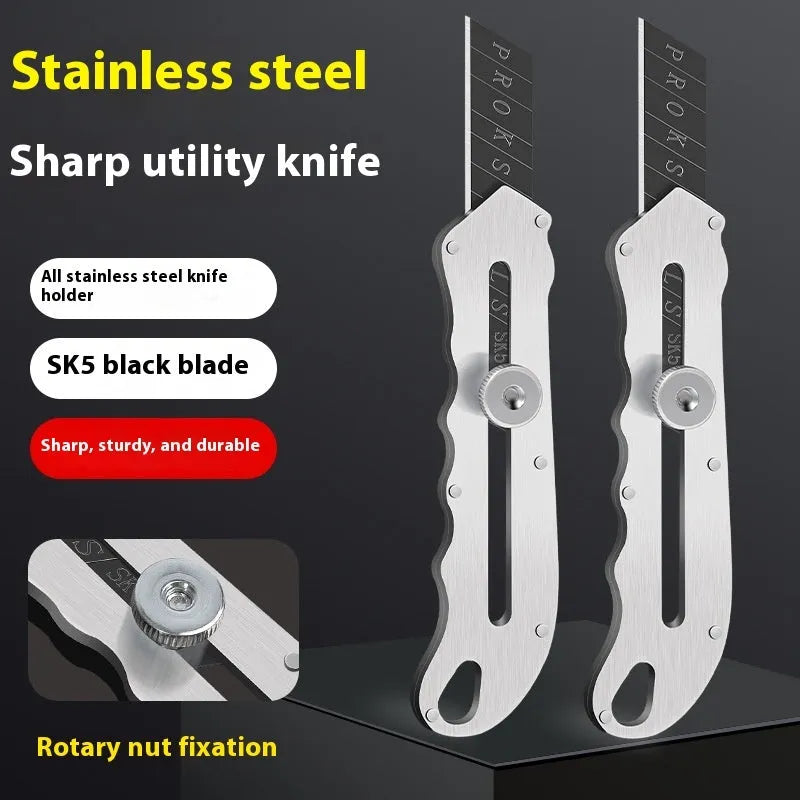 Stainless steel folding art knife with black blade and 20 spare blades on a work surface