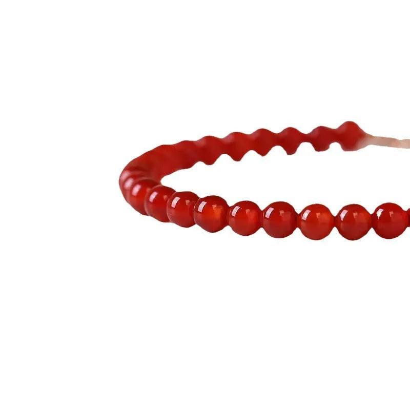 Ultra-thin red agate small bracelet for women, classic style, on a plain background.