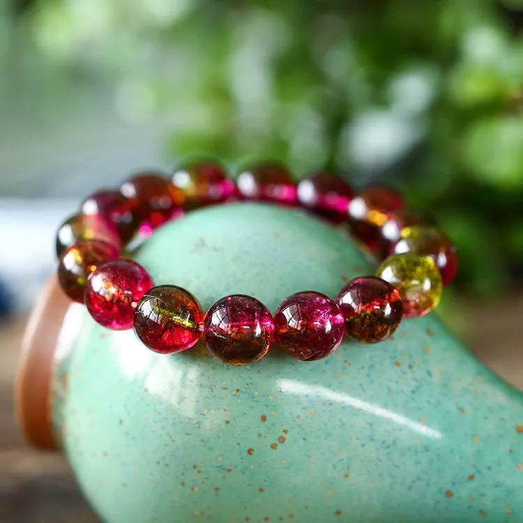 Handmade watermelon crystal bracelet for women showing pastoral design on a wrist.