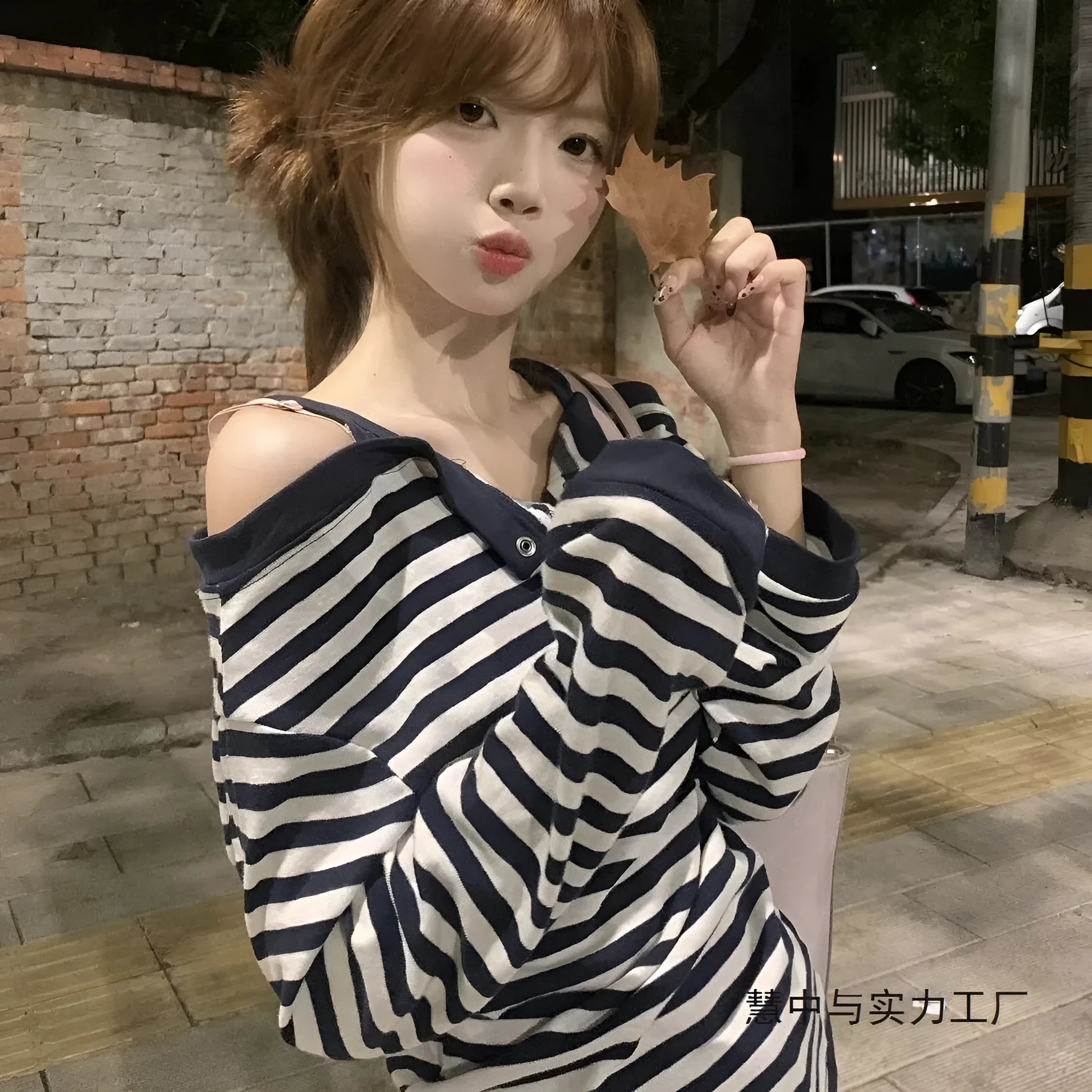 Dark blue women's oversized long-sleeve T-shirt with stripes, buttons, and embroidery details.