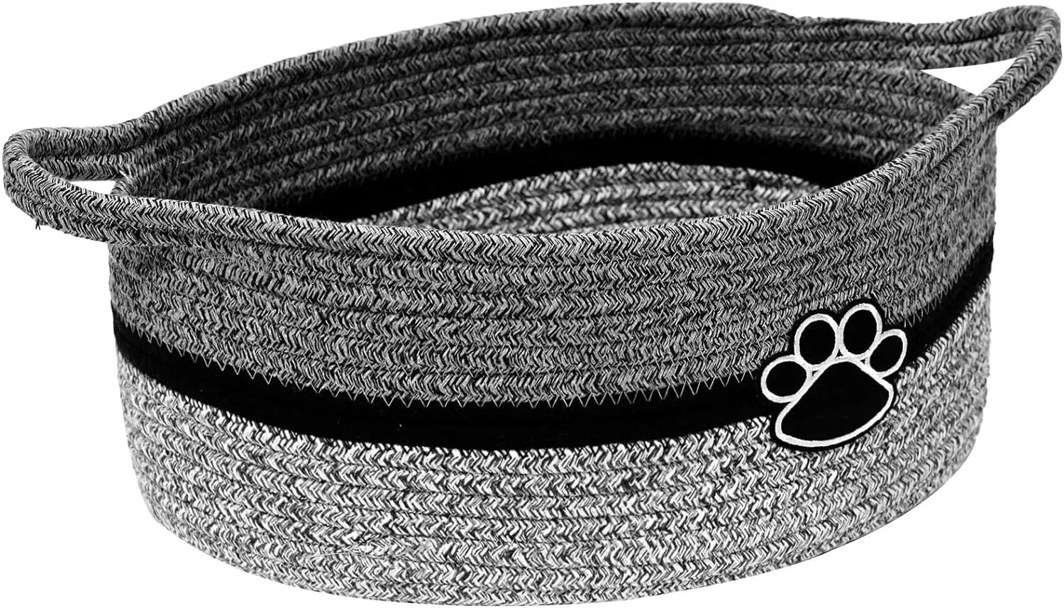 Small light beige woven cotton rope storage basket with handles on a wooden surface.