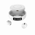 Mini black and white semi-in-ear wireless headphones with their wireless charging compartment.