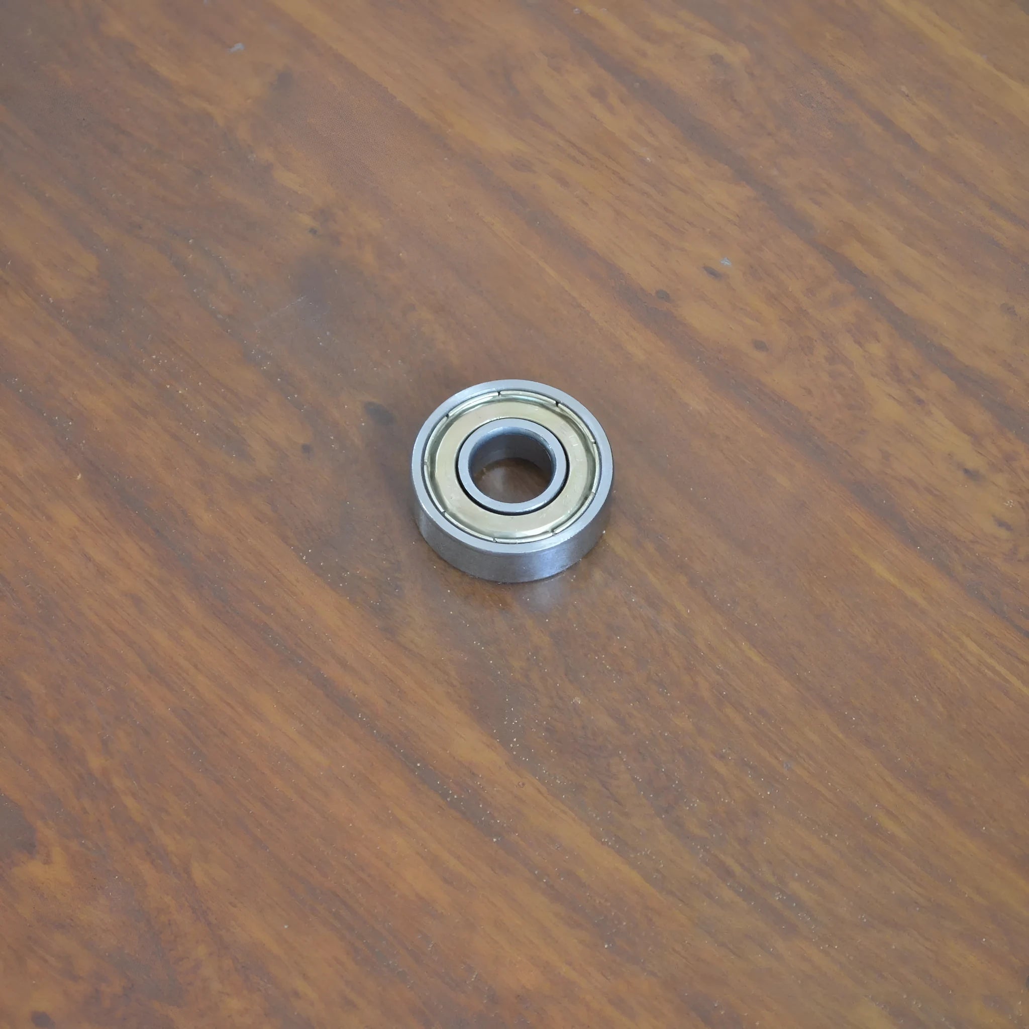 Carbon steel bearing 6000zz with dimensions 10x26x8mm on a white background