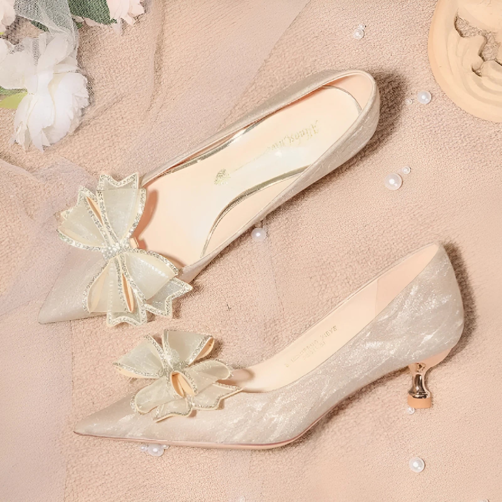 Champagne sequined women's stiletto pump with pointed toe and a high heel on a rubber sole.