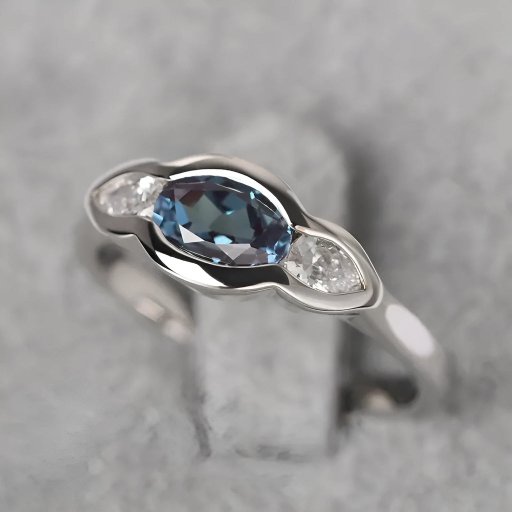 Women's geometric ellipse ring in white gold tone with inlaid zircon detailing, showing contemporary design