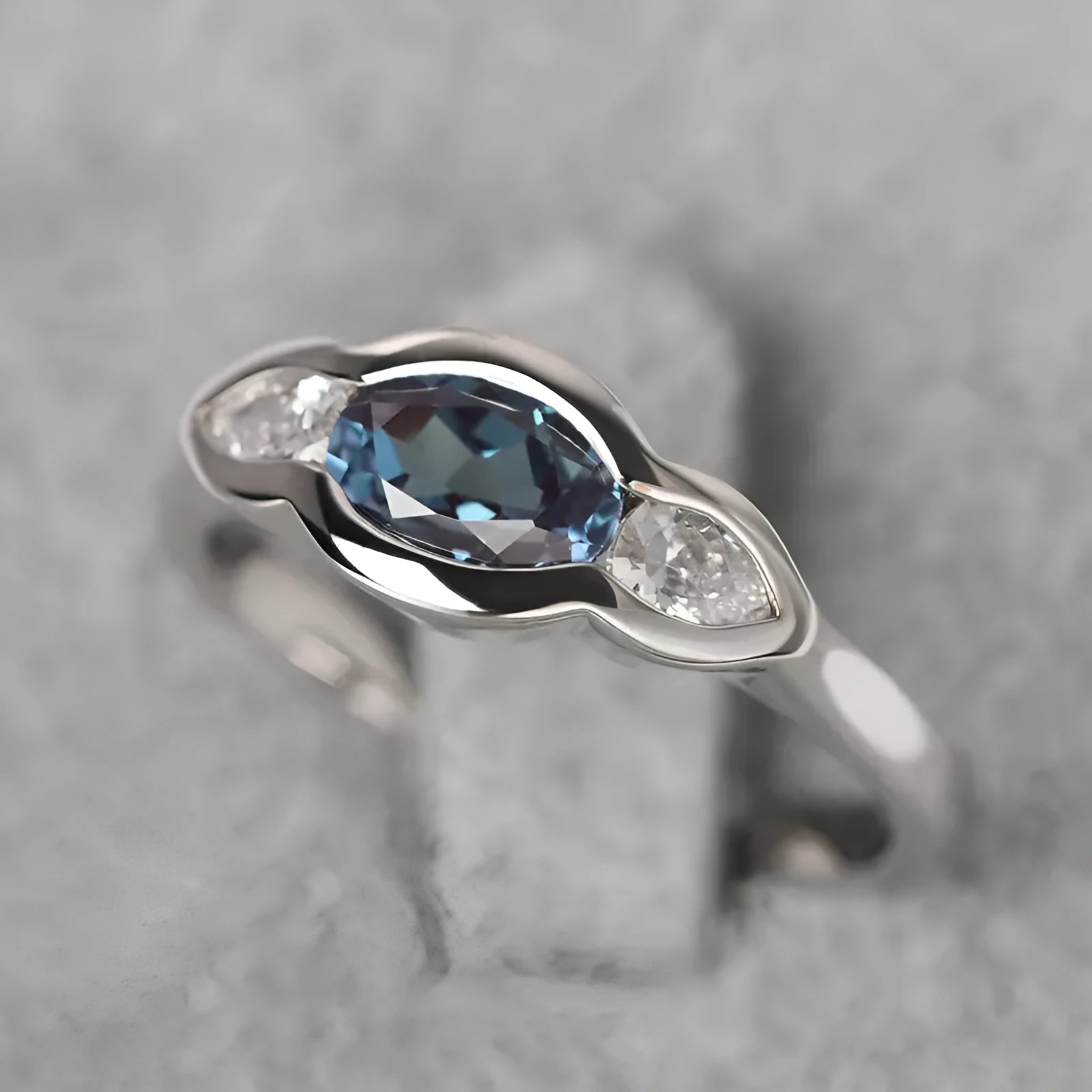 Women's geometric ellipse ring in white gold tone with inlaid zircon detailing, showing contemporary design