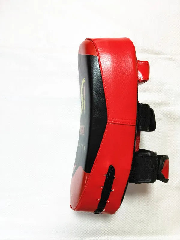 Black and red square hand-held martial arts foot target pad with buckle straps.