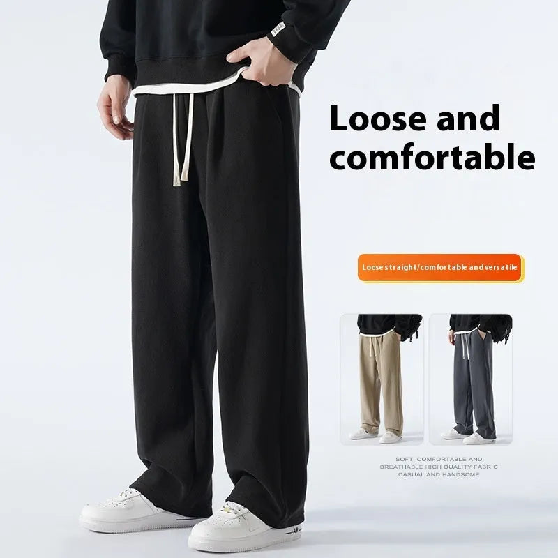 Men's apricot double-sided polar fleece winter trousers with a loose fit and drawstring waistband on a hanger.