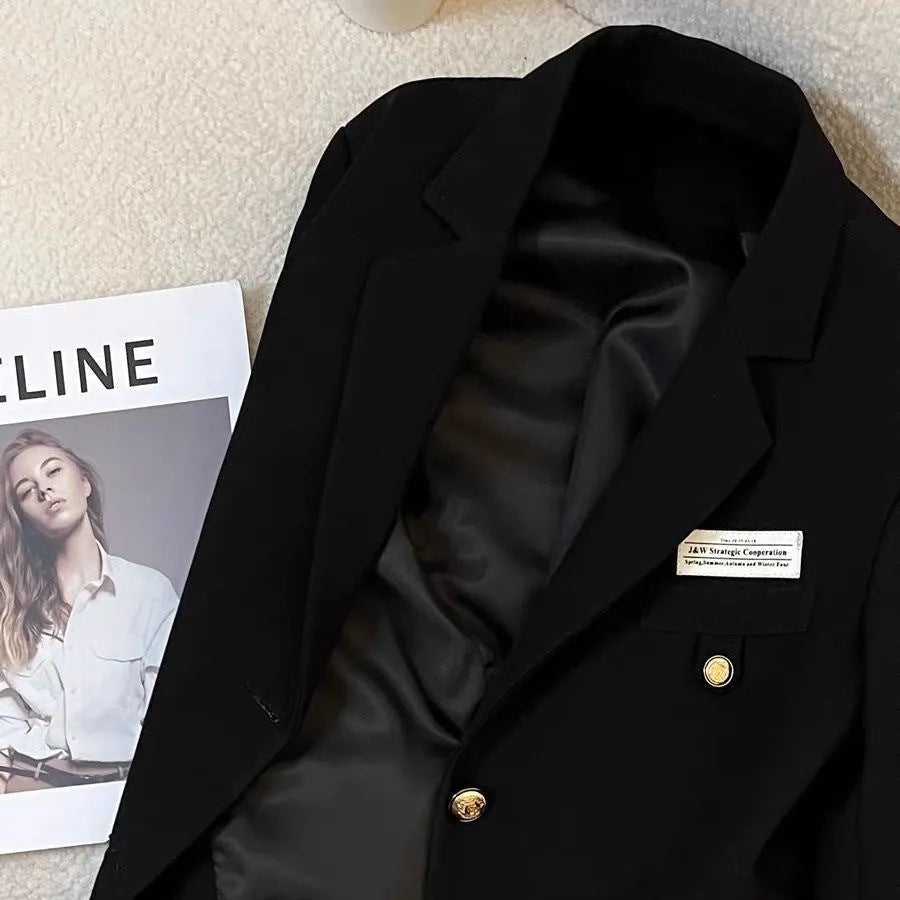 Women's black polyester short suit coat with loose fit and hip-length design
