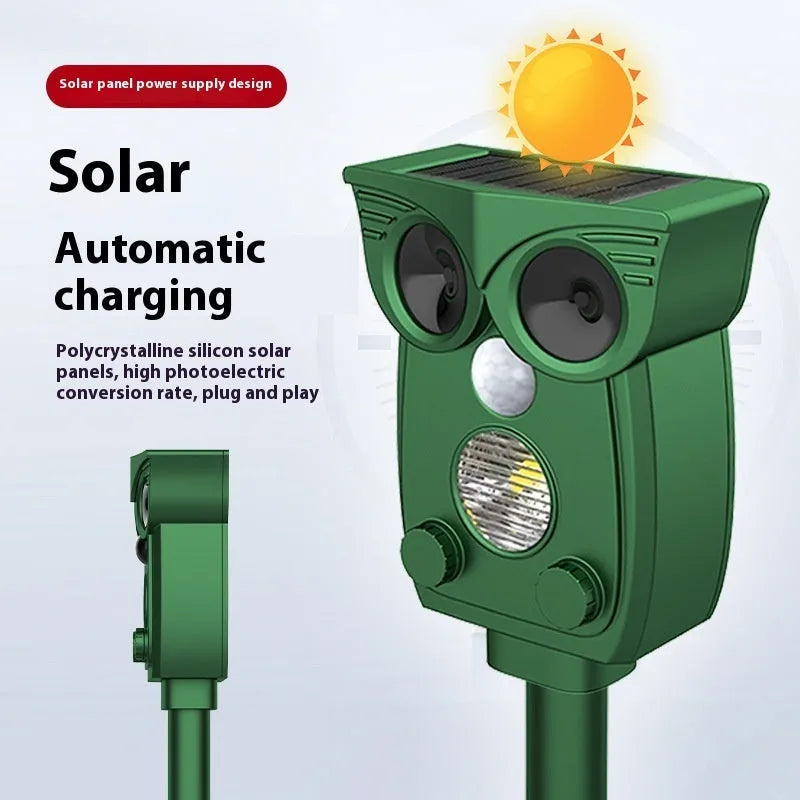 Dark green solar-powered infrared animal repeller with plastic body on grass