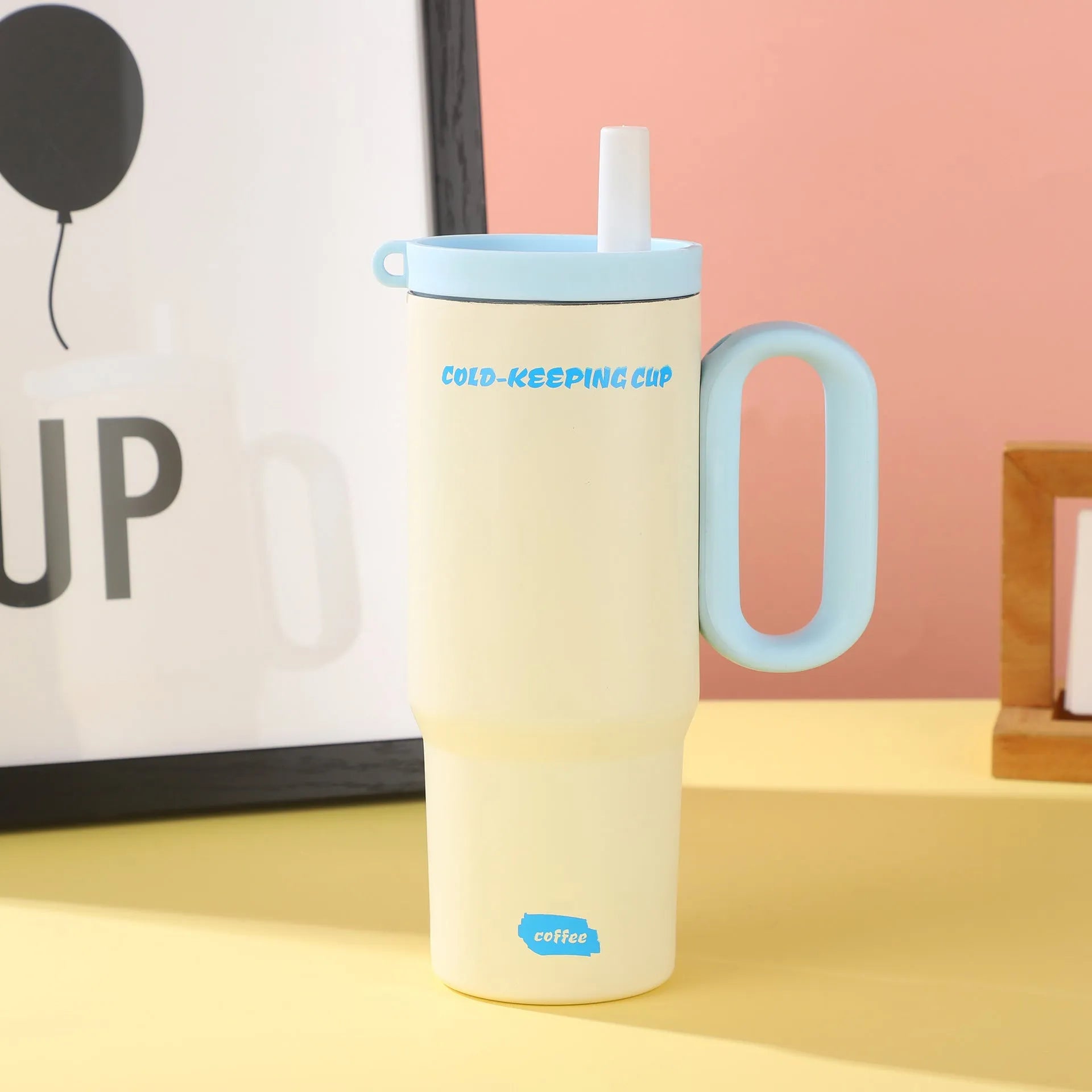 Portable insulated drink cup with carry handle and straw lid in multiple colours