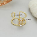 Gold tone adjustable open ring with U-shaped design and asymmetrical silhouette