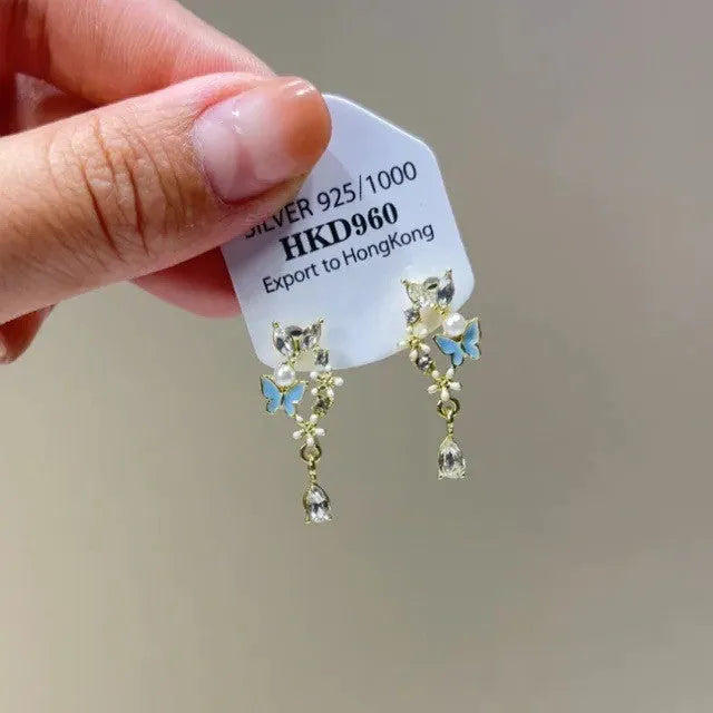 Geometric heart-shaped women's ear clip with rhinestones and a dangling tassel.