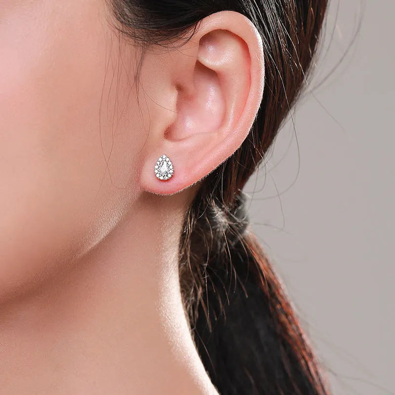 Silver waterdrop shaped ear studs with diamond-cut finish on 925 sterling silver