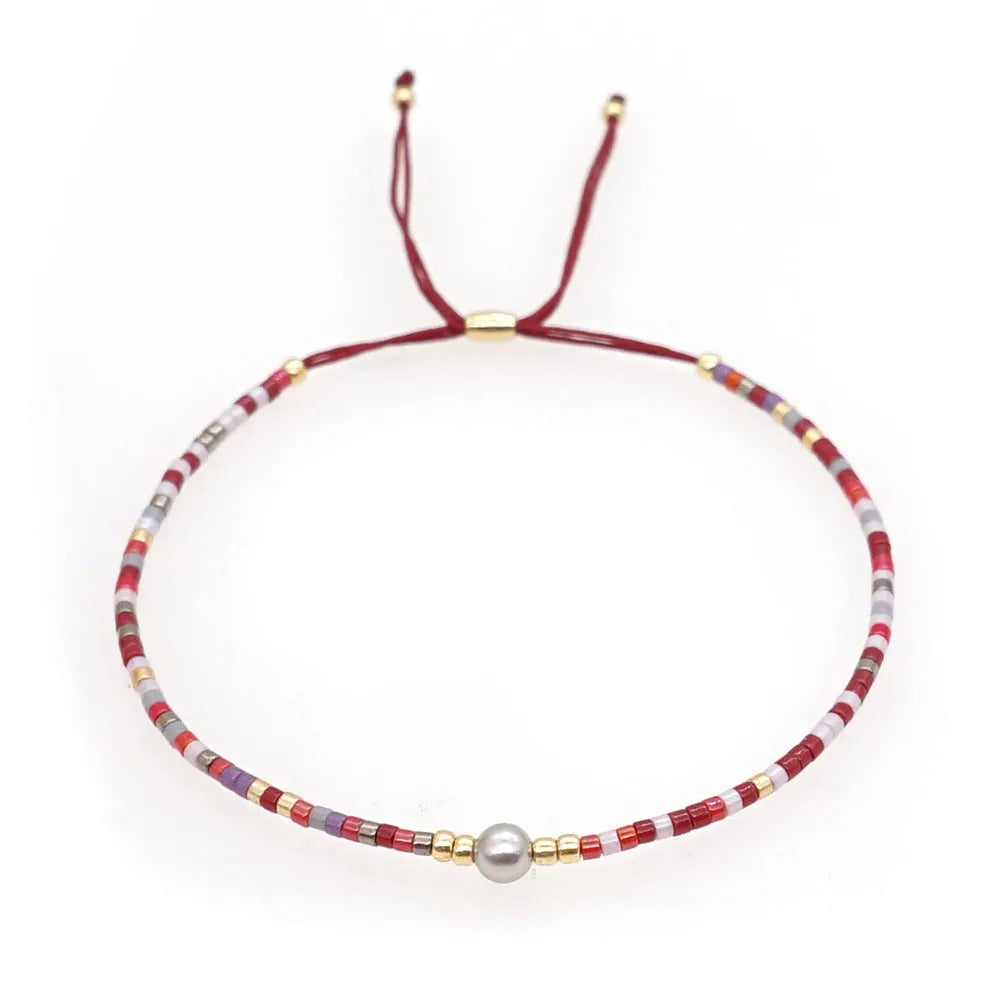 Women's colourful bohemian style beaded bracelet with geometric shaped glass and coloured glaze beads