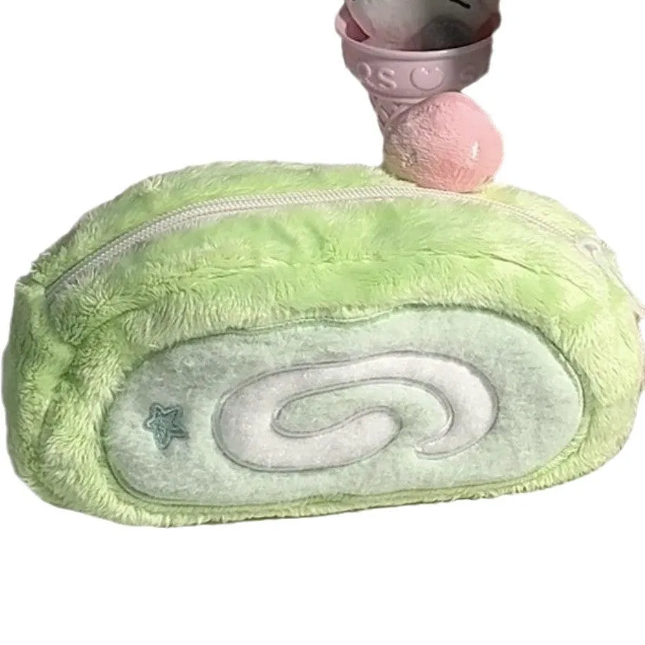 Honeydew Roll plush velvet pencil case with Swiss roll cake design on a desk.