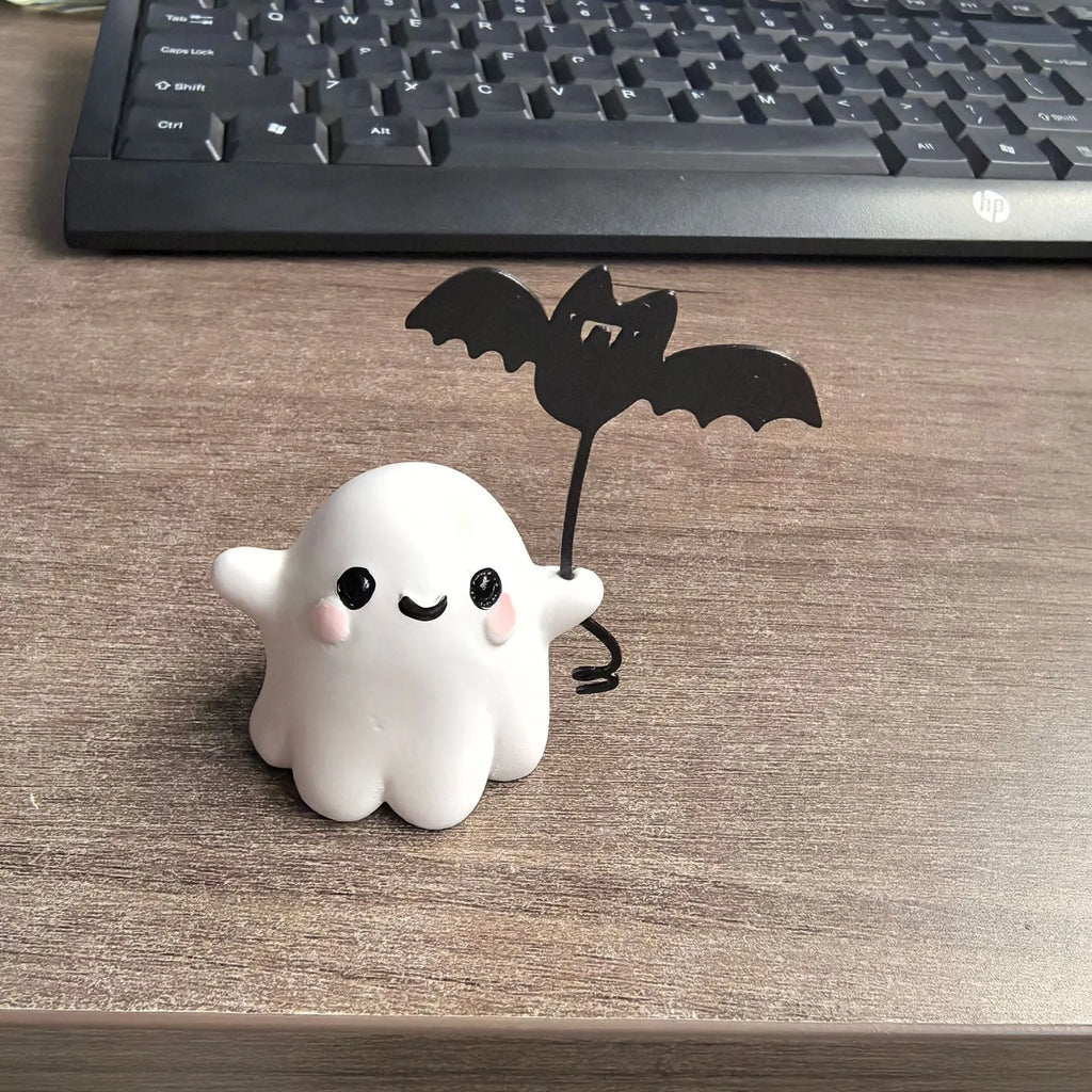 Mini resin ghost dog statue holding a bat, a Halloween decoration measuring 4cm.