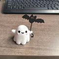 Mini resin ghost dog statue holding a bat, a Halloween decoration measuring 4cm.
