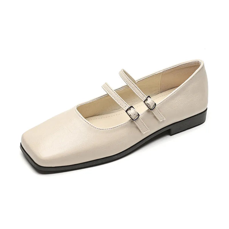 Women's silver leather Mary Jane pumps with a cross buckle strap and flat sole.
