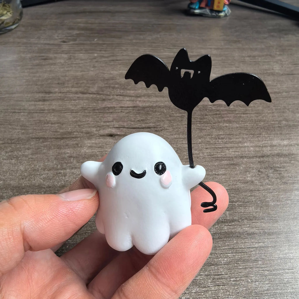 Mini resin ghost dog statue holding a bat, a Halloween decoration measuring 4cm.