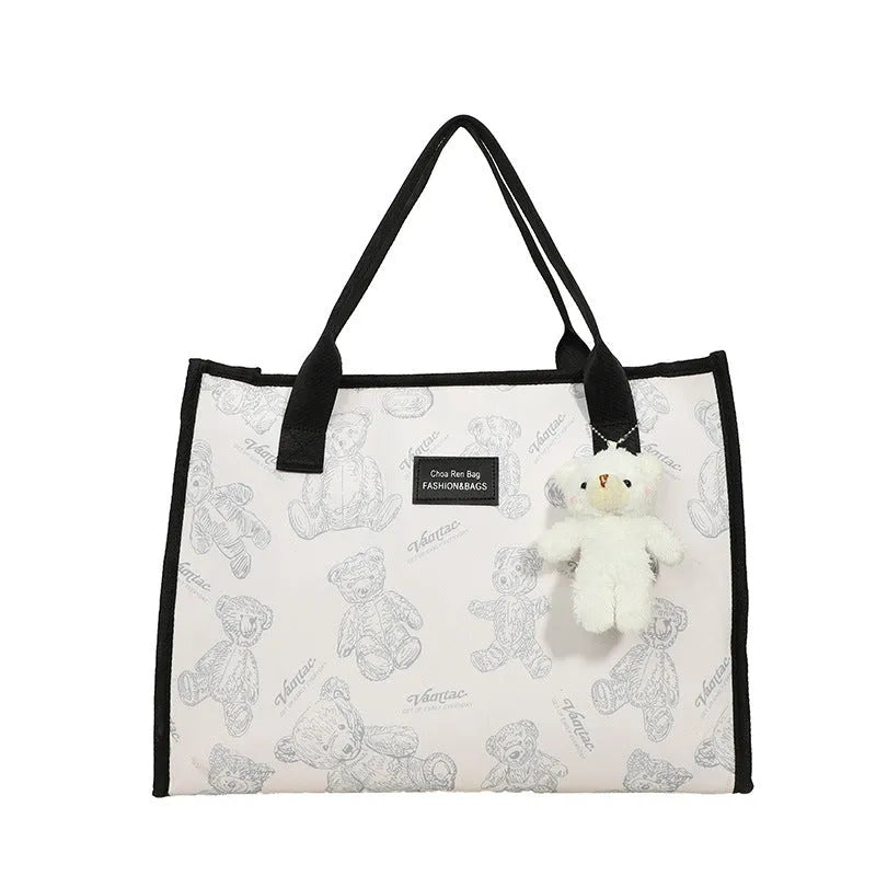 Women's printed canvas tote bag with large capacity, shown in black and white colour options with optional pendant
