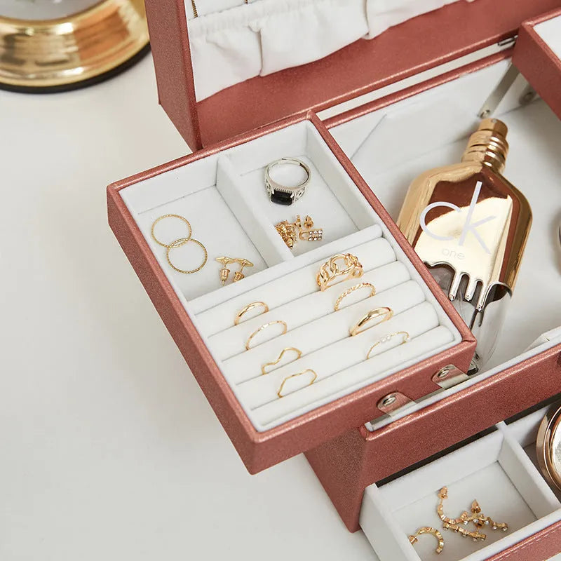 Hard PU leather jewellery storage box with velvet-lined interior compartments in beige colour.