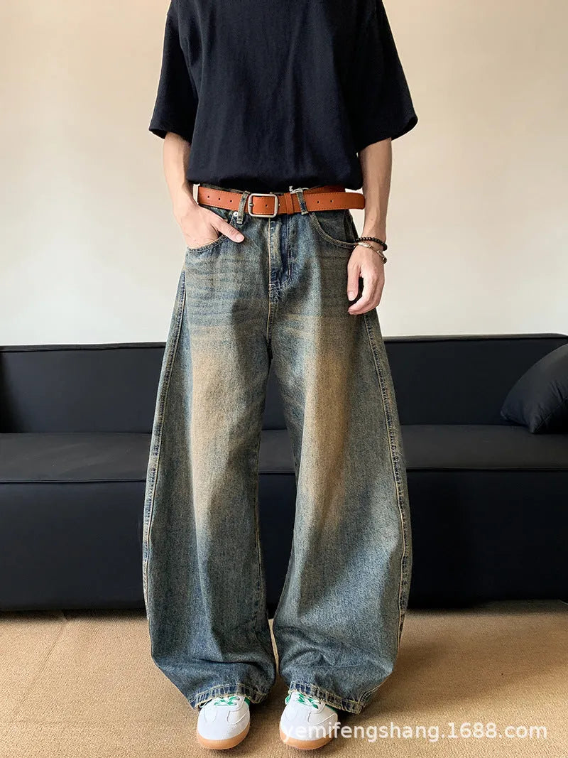 Men's retro blue distressed denim trousers with wide leg cut and vintage wash detailing