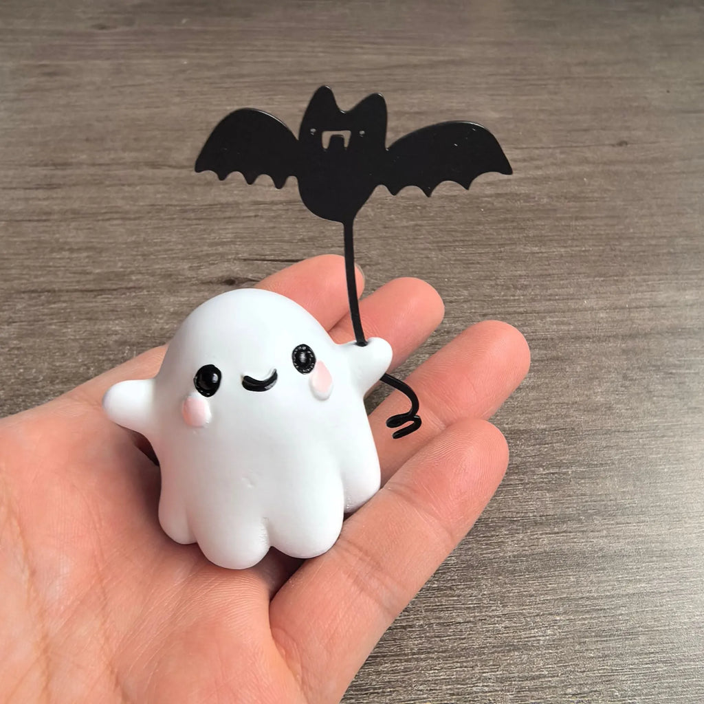 Mini resin ghost dog statue holding a bat, a Halloween decoration measuring 4cm.