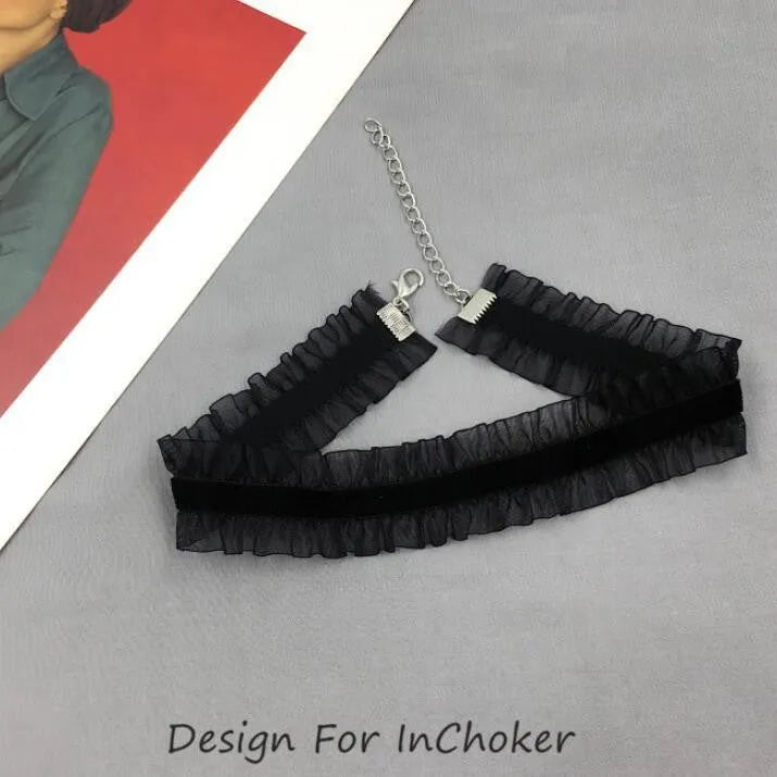 Close-up of an alloy necklace with a velvet-textured ruffled flower pendant on a snake bones chain.