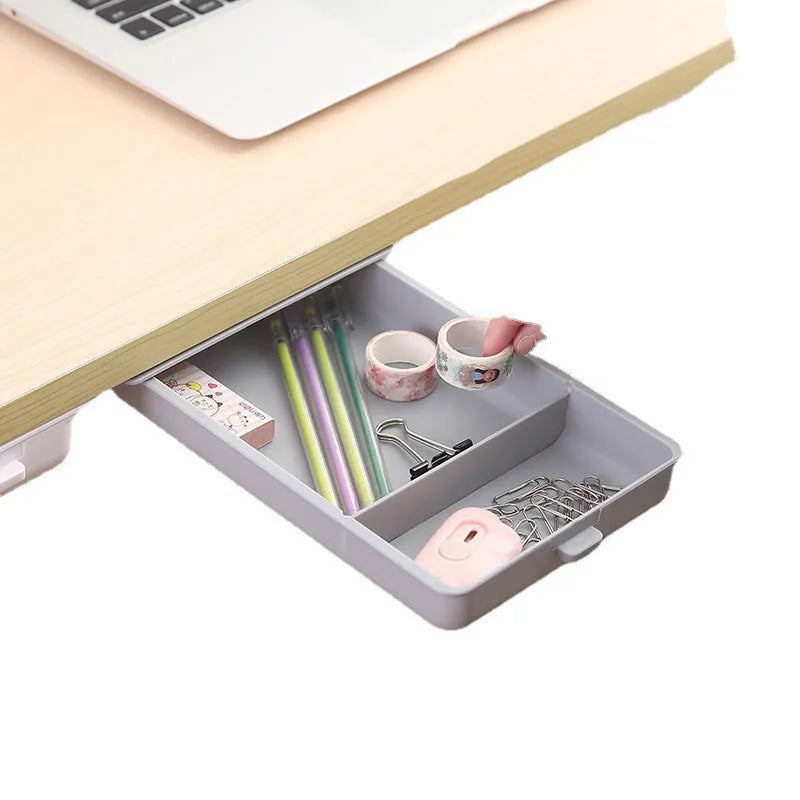 White plastic under-desk storage box with a lid open, showing an internal grid pattern.