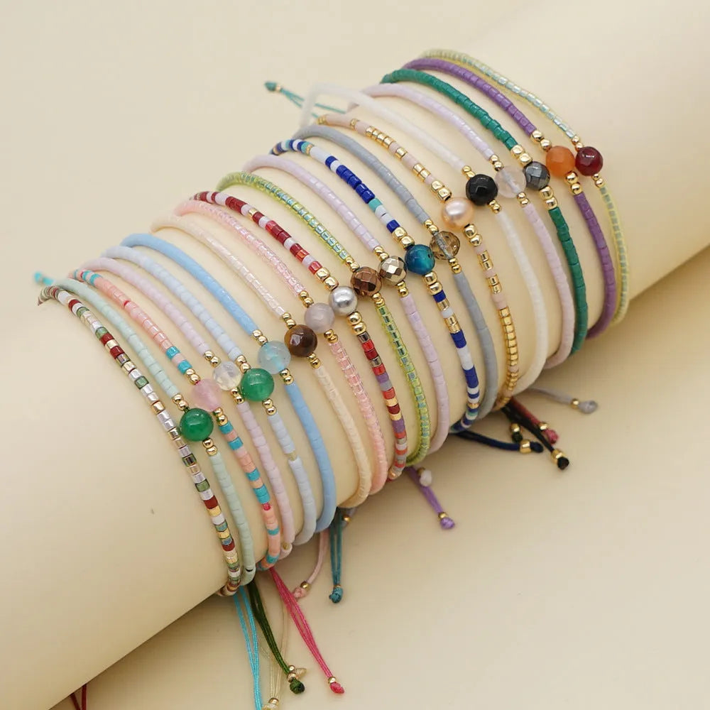 Women's colourful bohemian style beaded bracelet with geometric shaped glass and coloured glaze beads