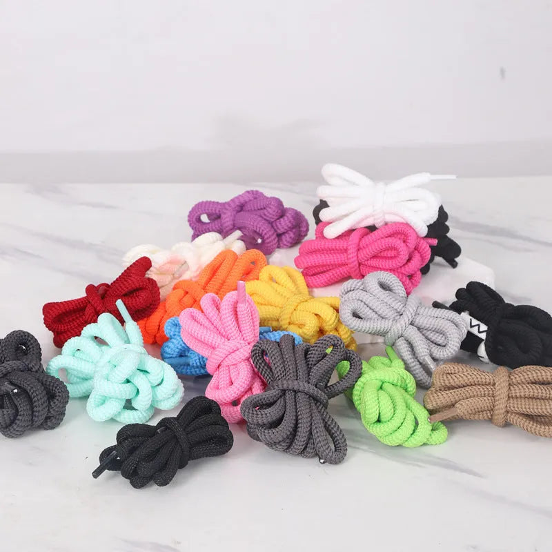 Round 1.0cm wide shoelace adapters in multiple colours including black, pink, blue, and grey on a white background.