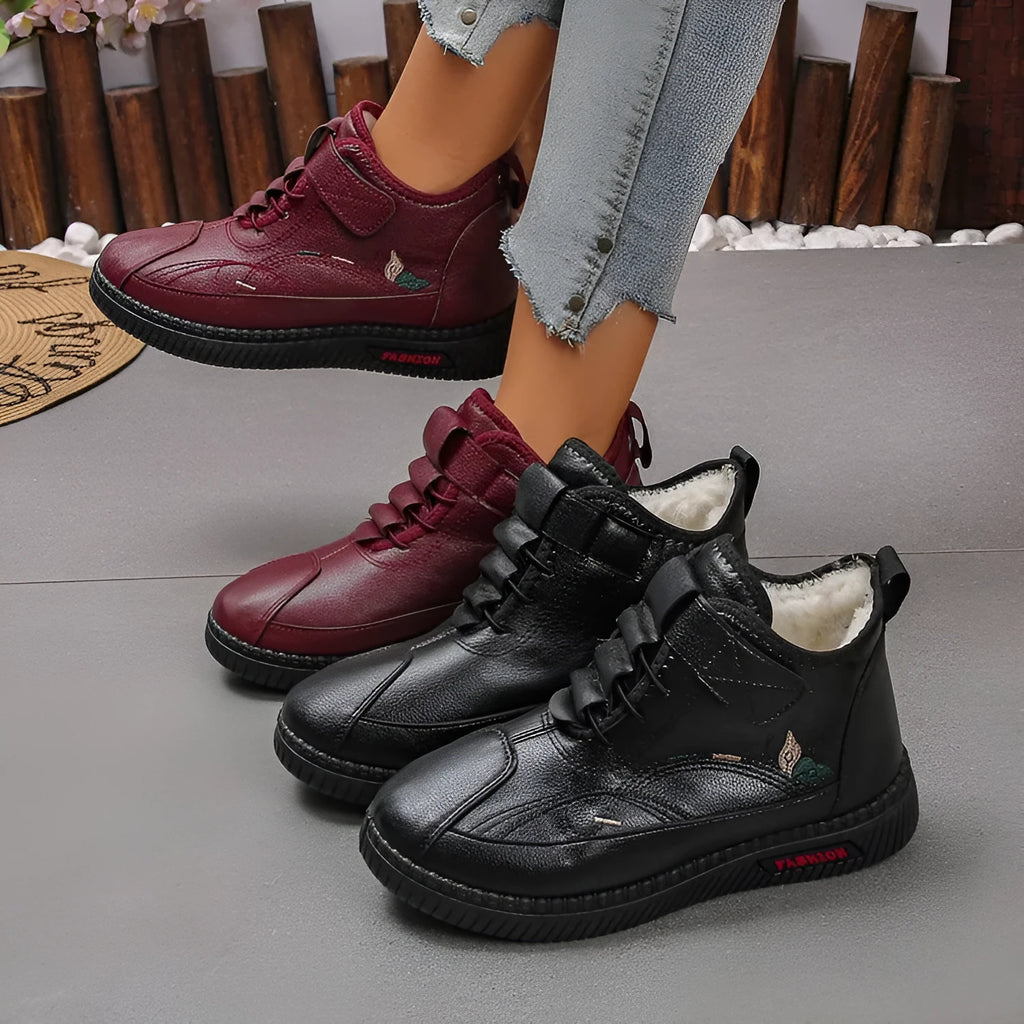 Women's black velvet plimsoll with non-slip rubber sole and hollow-out detailing