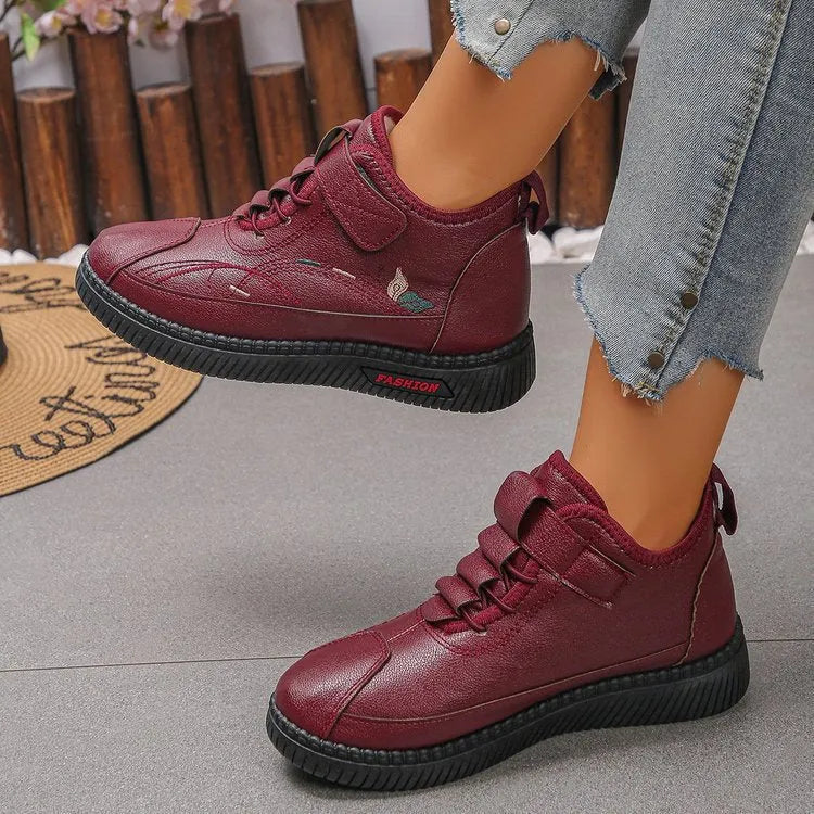 Women's black velvet plimsoll with non-slip rubber sole and hollow-out detailing