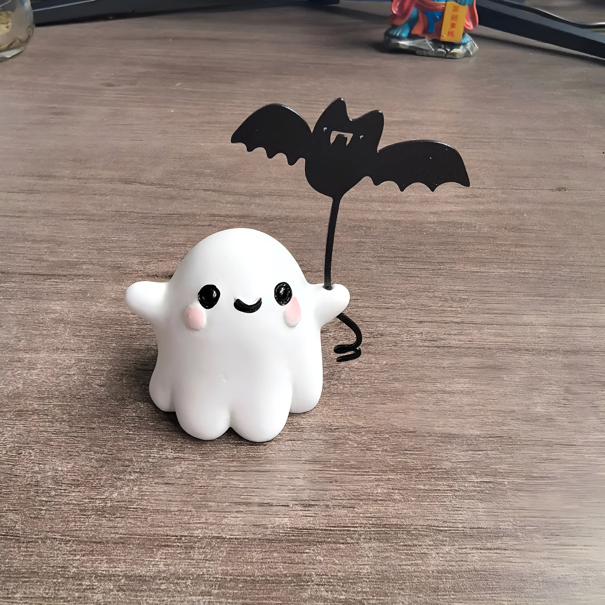 Mini resin ghost dog statue holding a bat, a Halloween decoration measuring 4cm.