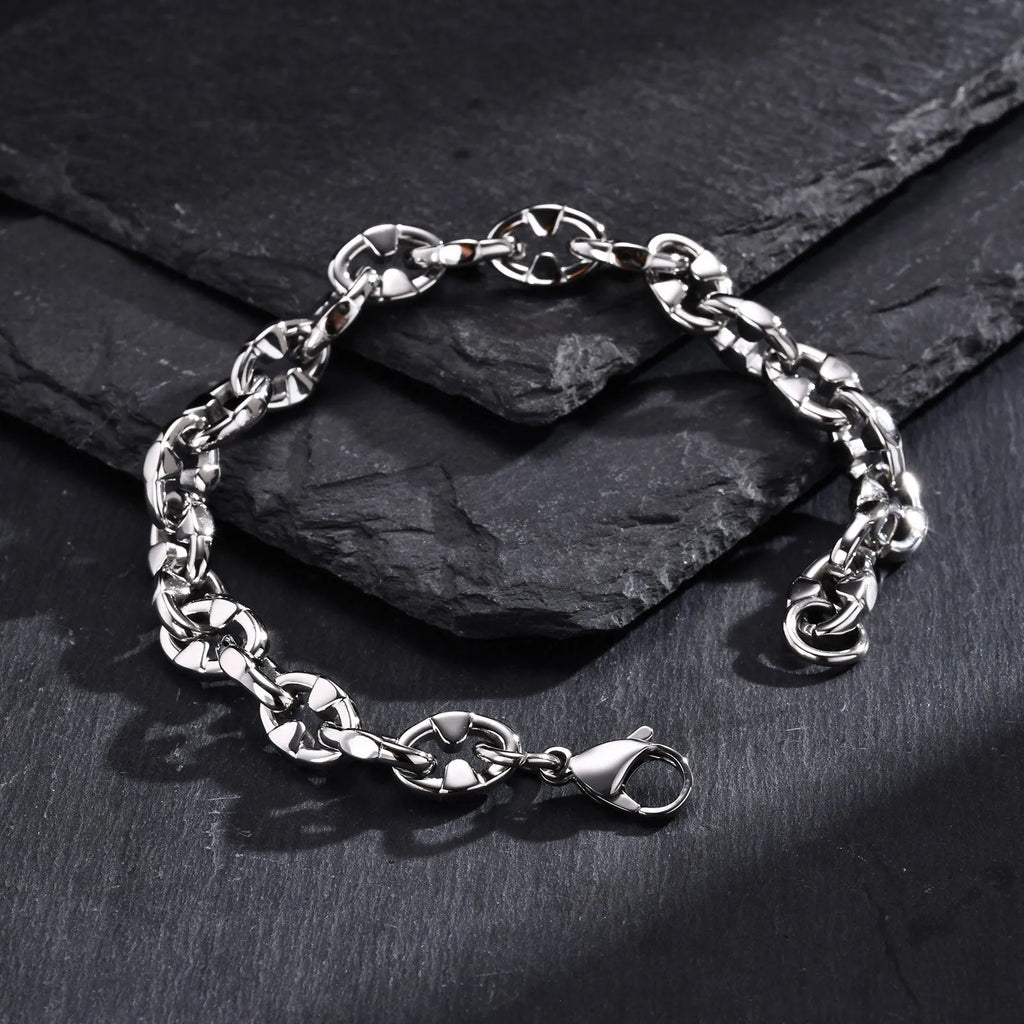 Men's stainless steel handmade geometric chain bracelet in steel colour on a wrist.