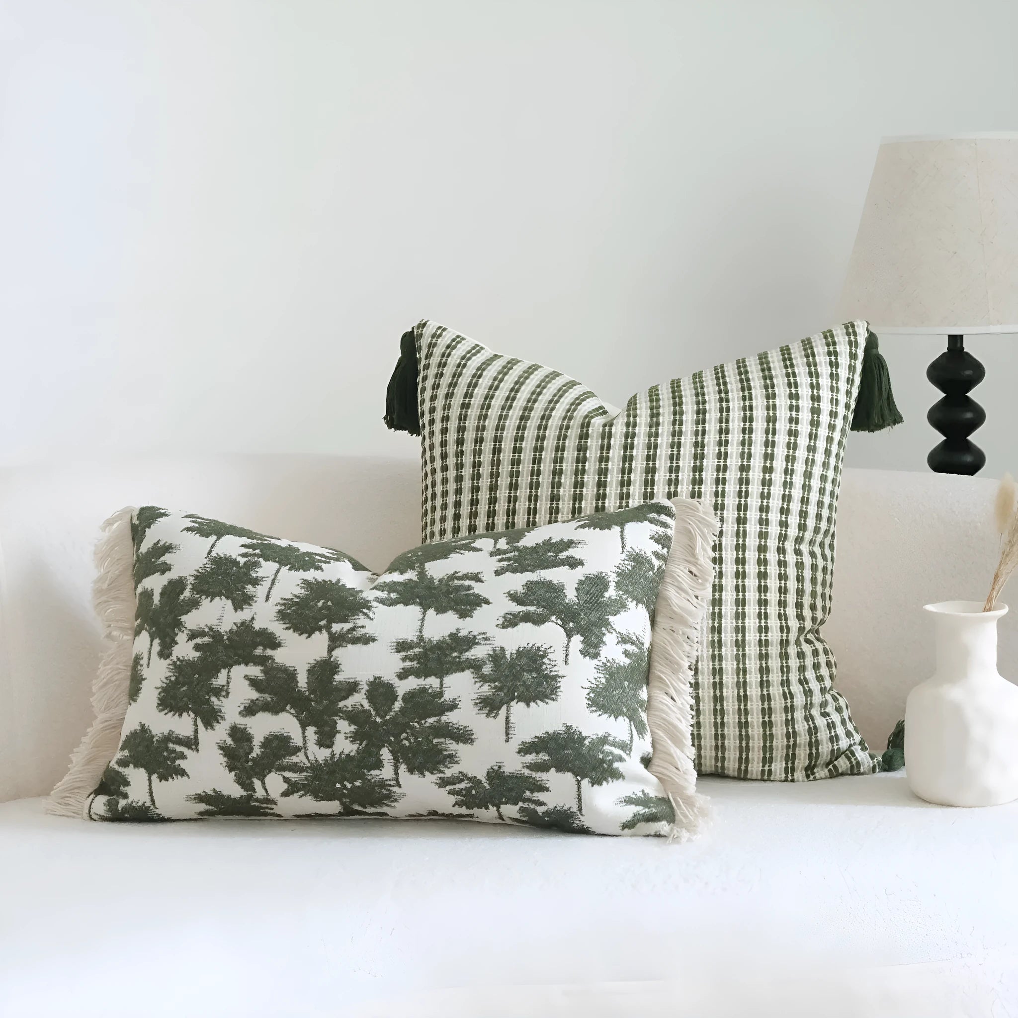 Green cotton and linen hotel sample pillow with botanical pattern and tassel trim, shown with separate pillow core.