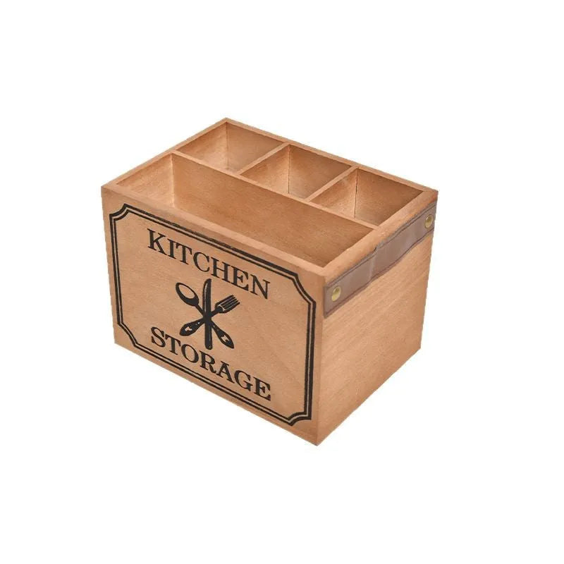 Open wooden kitchen storage box with internal grid holding knives, forks, and chopsticks.