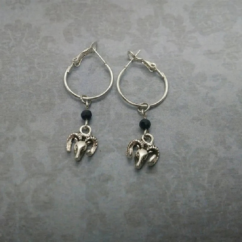 A pair of silver round ring earrings with a Tibetan antelope design.