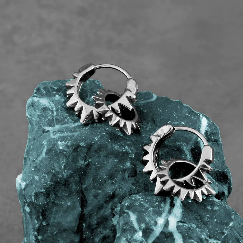A pair of polished stainless steel round hoop earrings in a steel colour with a simple, retro design.